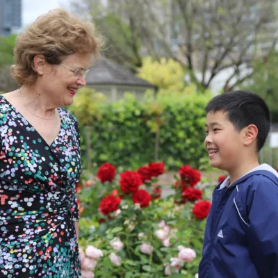 Governor with child visitor in Governors Rose Garden