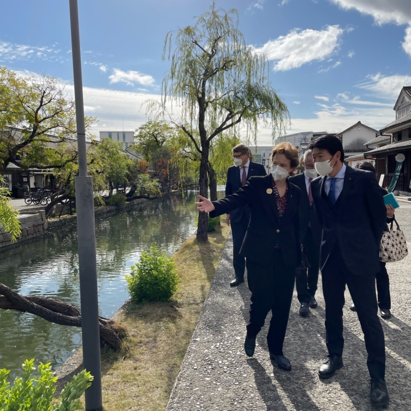 Her Excellency the Governor walking through Tokyo's Kurashiki Historical Quarter, speaking with a man.