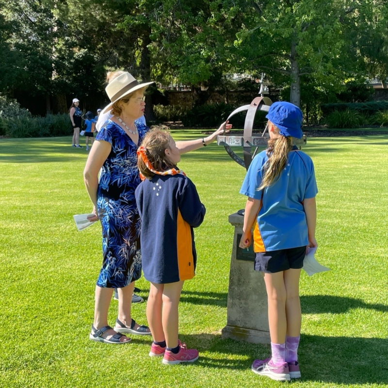 Her Excellency explaining the significance of the Government House sundial to two Girl Guides