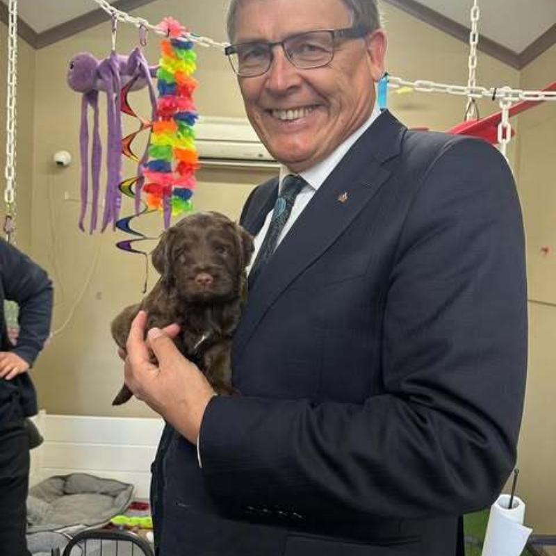 Mr Bunten with a dog from the Australian Lions Hearing Dogs national headquarters
